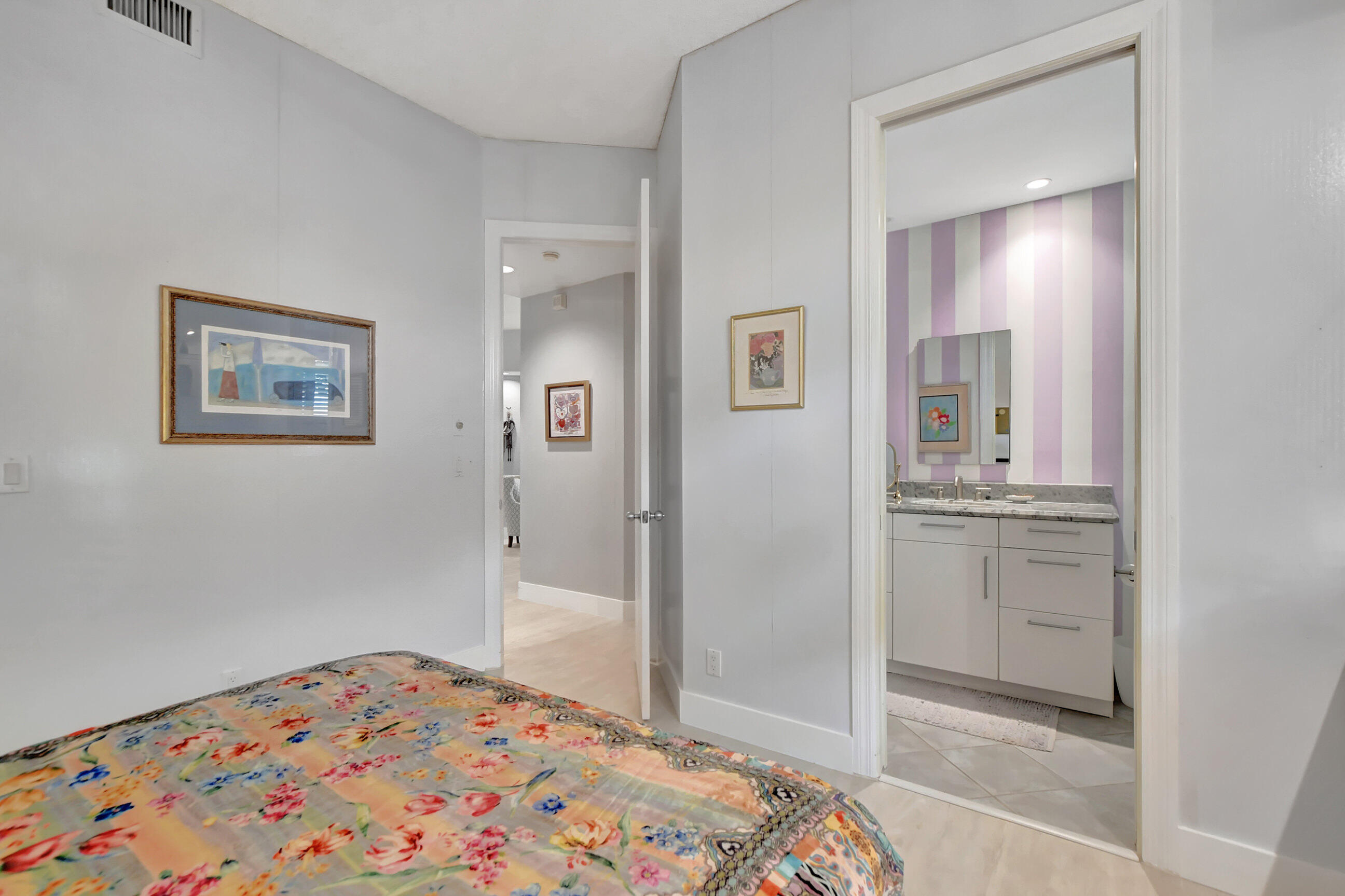 5801 Northwest 24th Avenue, Unit 1004 Boca Raton, FL 33496 - Photo 40 of 65 a bedroom with a bed and a view of bathroom