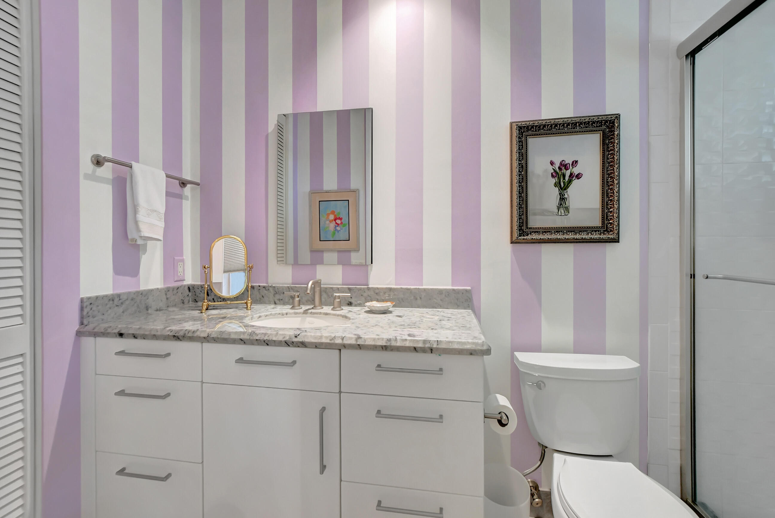 5801 Northwest 24th Avenue, Unit 1004 Boca Raton, FL 33496 - Photo 41 of 65 a bathroom with a granite countertop sink a toilet and a mirror