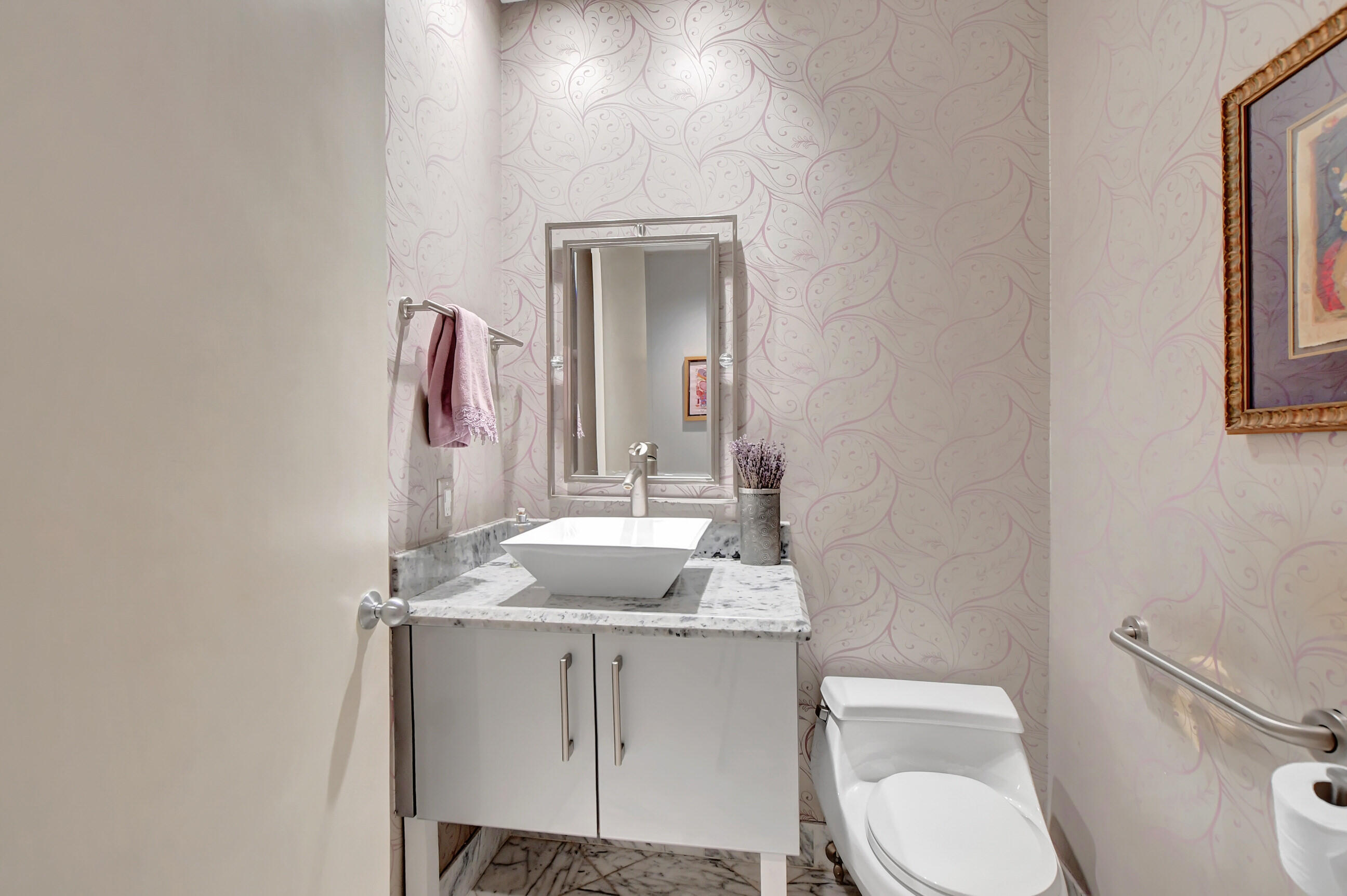 5801 Northwest 24th Avenue, Unit 1004 Boca Raton, FL 33496 - Photo 43 of 65 a bathroom with a toilet sink and mirror