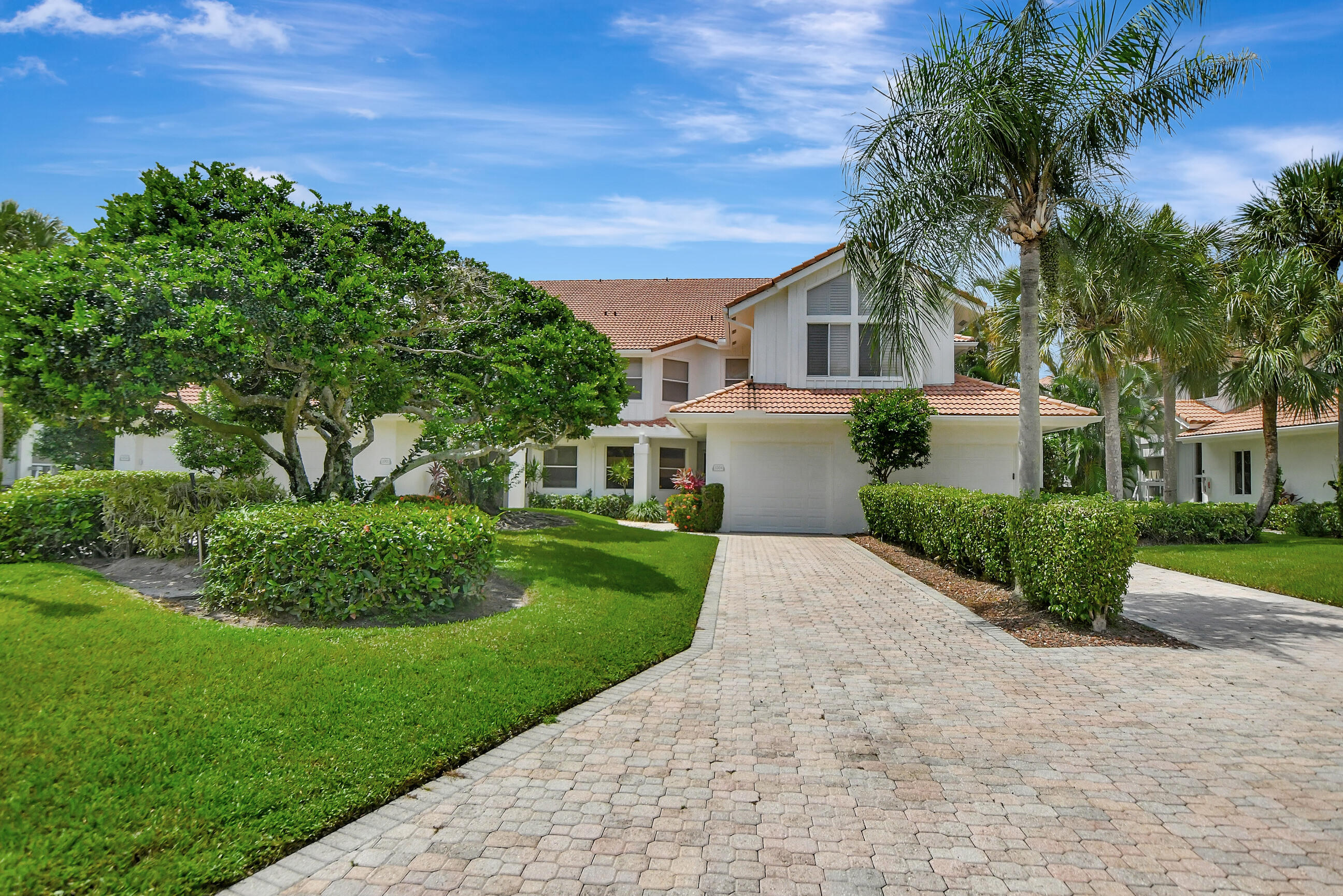 5801 Northwest 24th Avenue, Unit 1004 Boca Raton, FL 33496 - Photo 10 of 65 a front view of a house with a garden