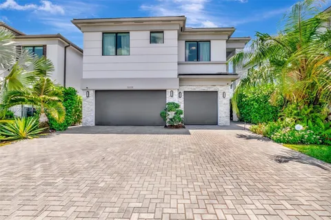 a front view of a house with a yard and a garage