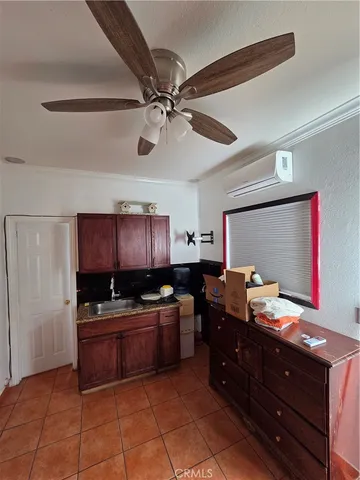 a kitchen with granite countertop a sink cabinets and stainless steel appliances
