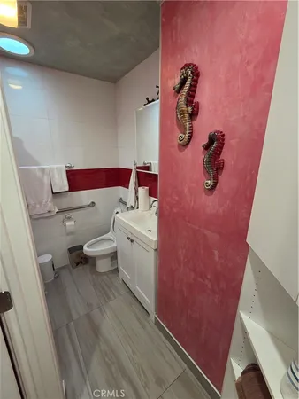 a bathroom with a granite countertop toilet and a shower
