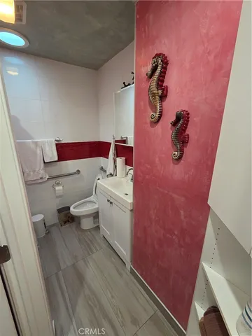 a bathroom with a granite countertop toilet and a shower