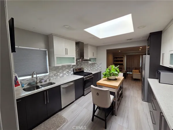 a kitchen with a table chairs stove and cabinets