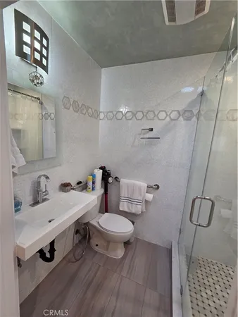 a bathroom with a sink toilet and a mirror