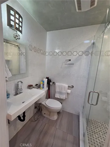 a bathroom with a sink toilet and a mirror