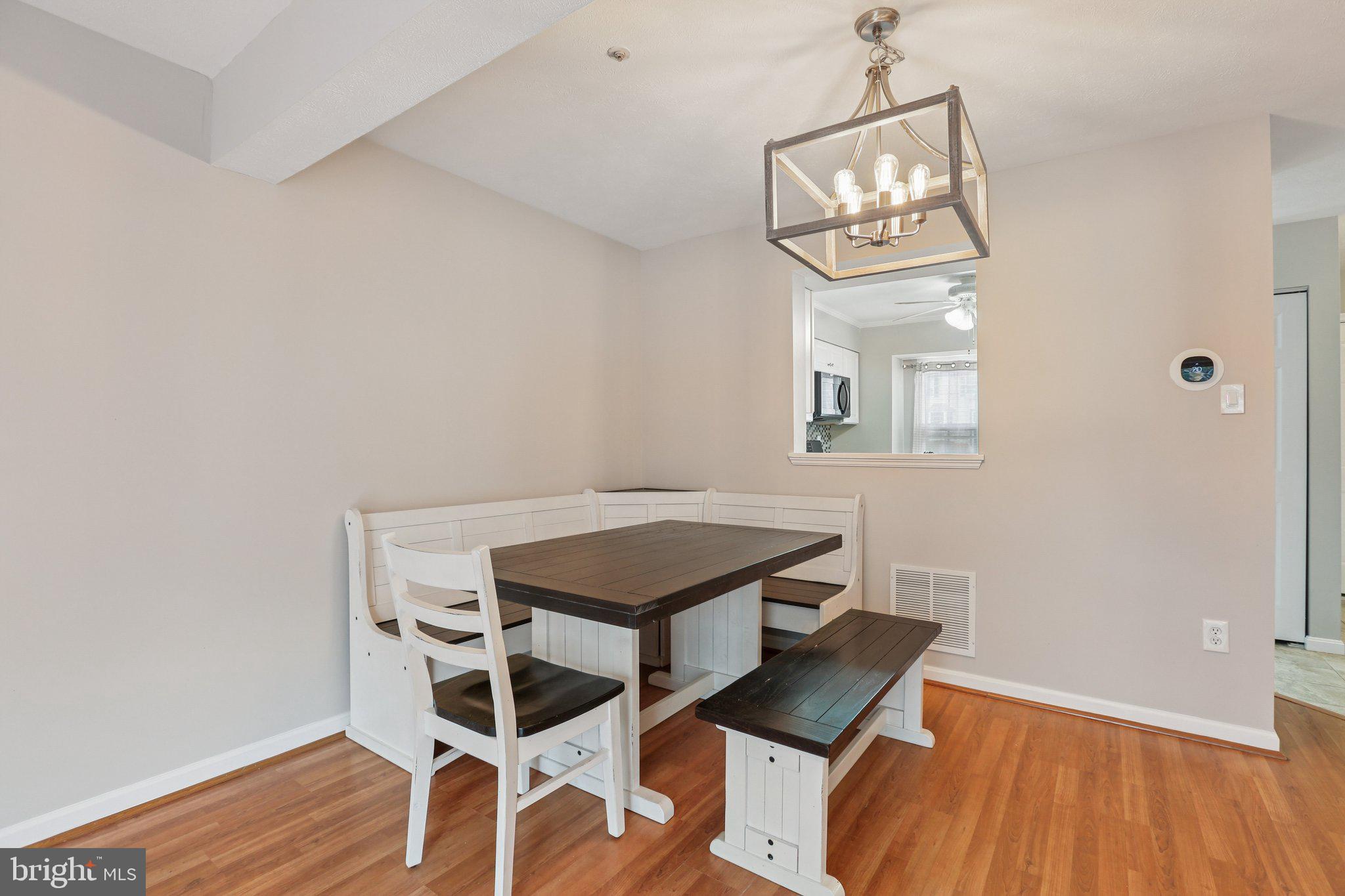 4642 Marksman Court Hampstead, MD 21074 - Photo 7 of 35 a view of a dining room with furniture and wooden floor