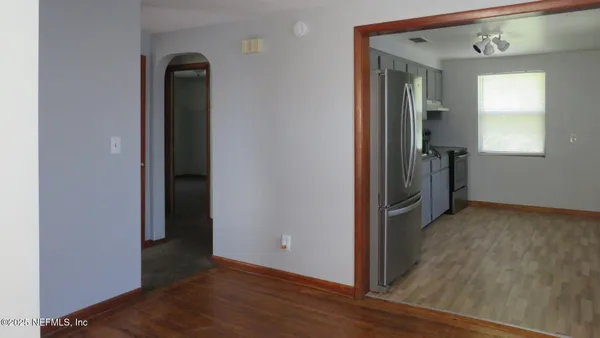 an empty room with wooden floor and closet