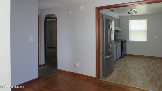 an empty room with wooden floor and closet