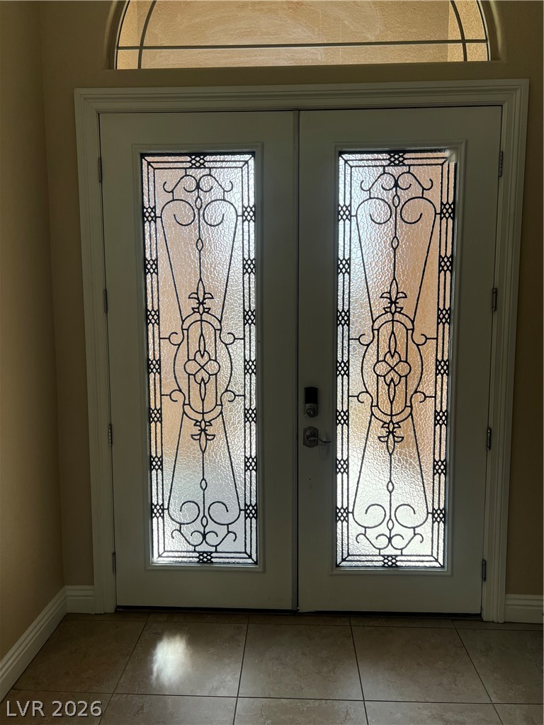 Undisclosed Address Las Vegas, NV 89129 - Photo 11 of 33 Entrance foyer with french doors and light tile patterned floors