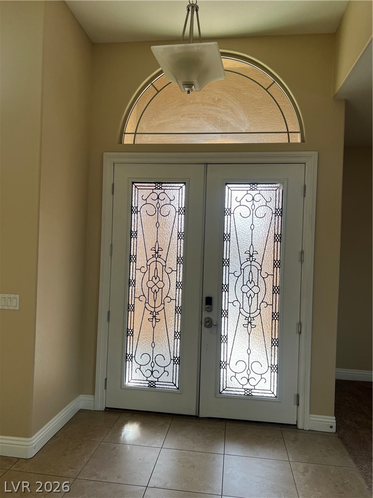 Undisclosed Address Las Vegas, NV 89129 - Photo 12 of 33 Foyer entrance featuring french doors and light tile patterned floors