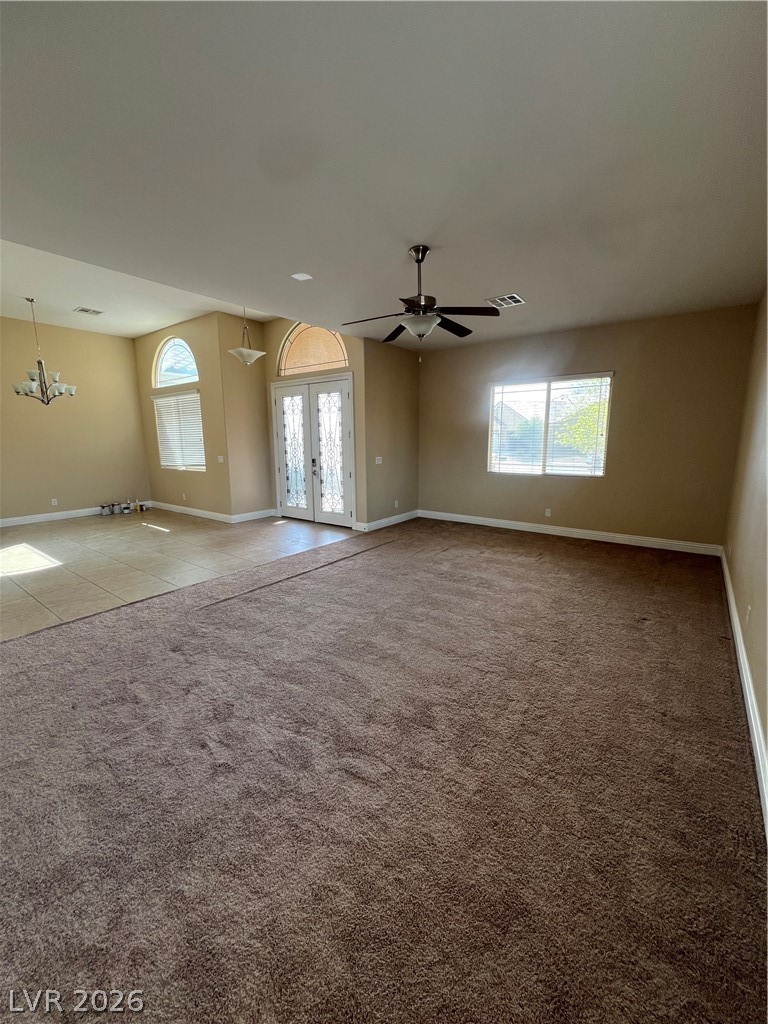 Undisclosed Address Las Vegas, NV 89129 - Photo 13 of 33 Unfurnished room featuring french doors, ceiling fan, and light carpet