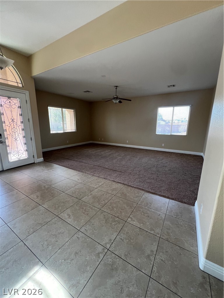 Undisclosed Address Las Vegas, NV 89129 - Photo 16 of 33 Foyer with light carpet, light tile patterned floors, healthy amount of natural light, and a ceiling fan