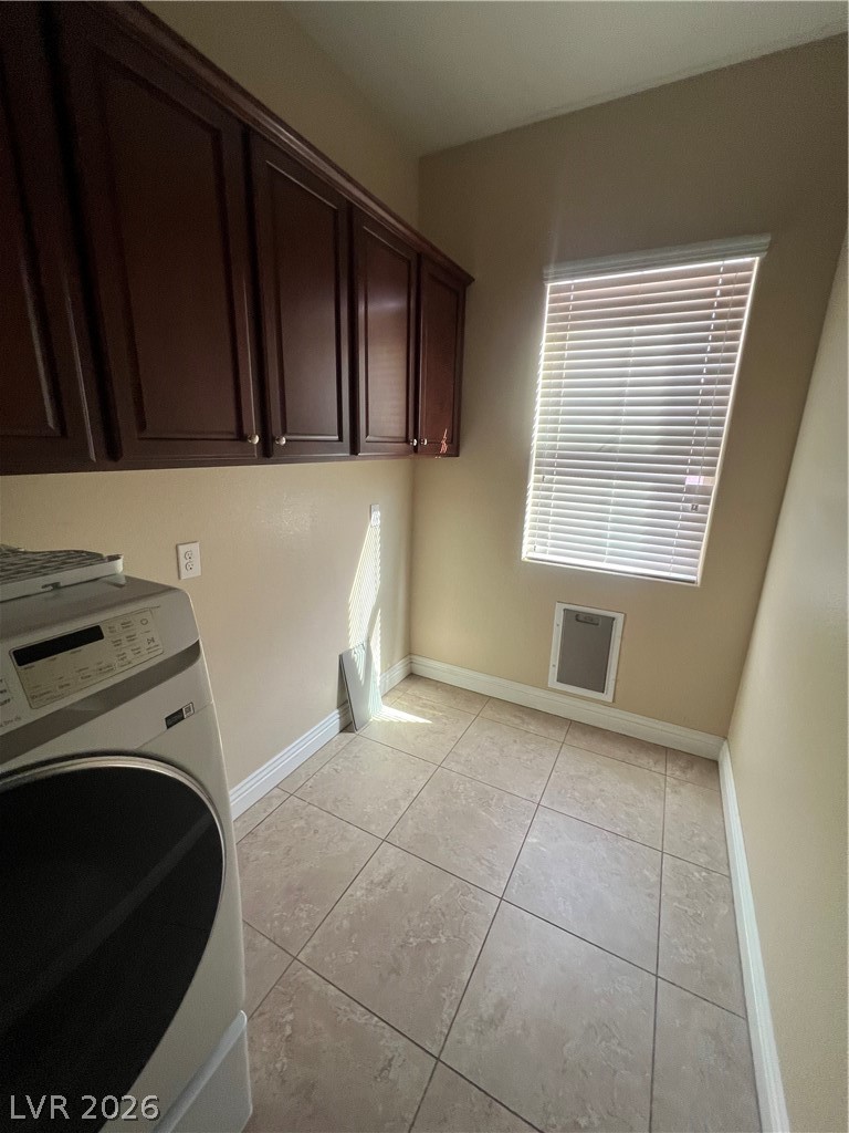 Undisclosed Address Las Vegas, NV 89129 - Photo 26 of 33 Laundry room featuring washer / clothes dryer, cabinet space, and light tile patterned floors