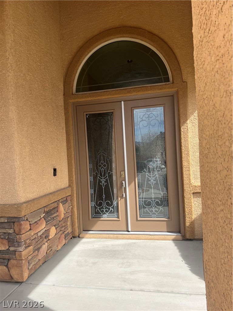 Undisclosed Address Las Vegas, NV 89129 - Photo 3 of 33 View of exterior entry featuring stucco siding and stone siding