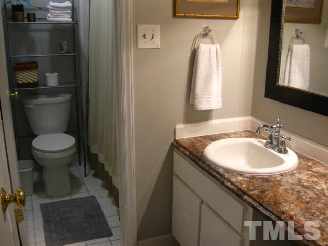 6455 New Market Way Raleigh, NC 27615 - Photo 12 of 18 a bathroom with a sink toilet and a mirror