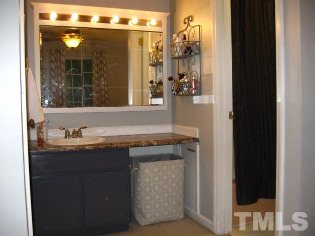 6455 New Market Way Raleigh, NC 27615 - Photo 15 of 18 a bathroom with a granite countertop sink mirror and shower