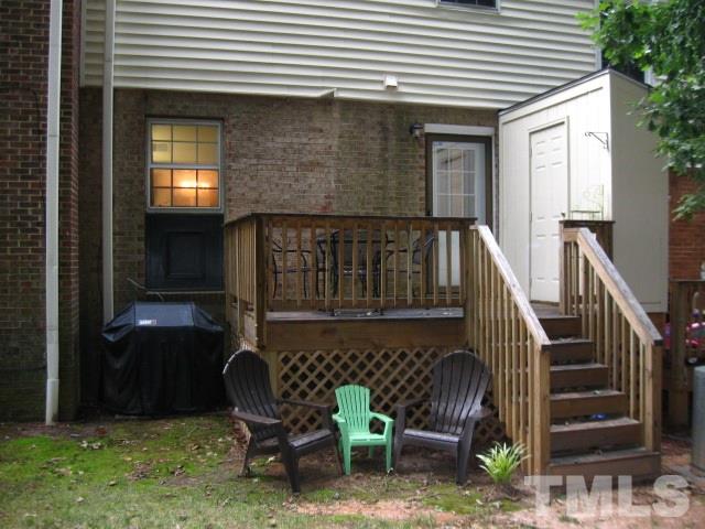 6455 New Market Way Raleigh, NC 27615 - Photo 16 of 18 a front view of a house with backyard and furniture