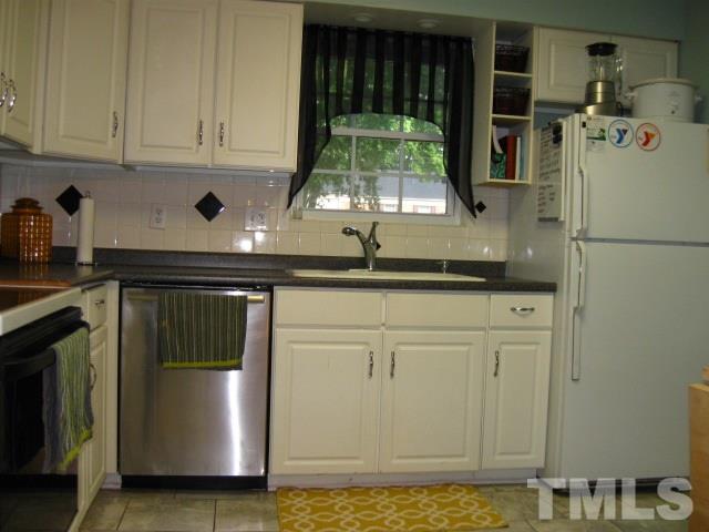 6455 New Market Way Raleigh, NC 27615 - Photo 5 of 18 a kitchen with a sink and a refrigerator