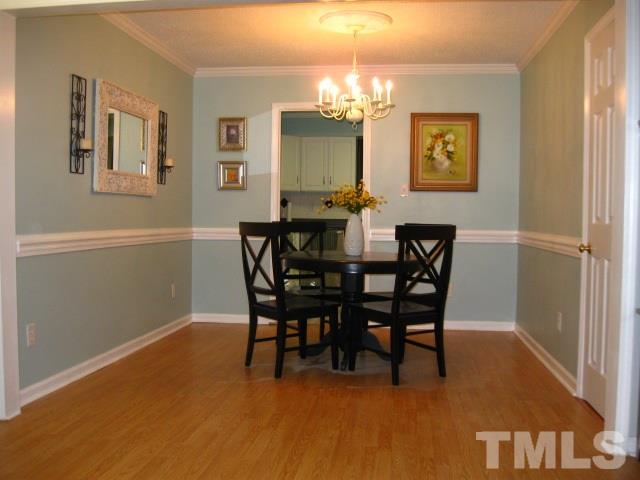 6455 New Market Way Raleigh, NC 27615 - Photo 7 of 18 a view of a dining room with furniture and chandelier