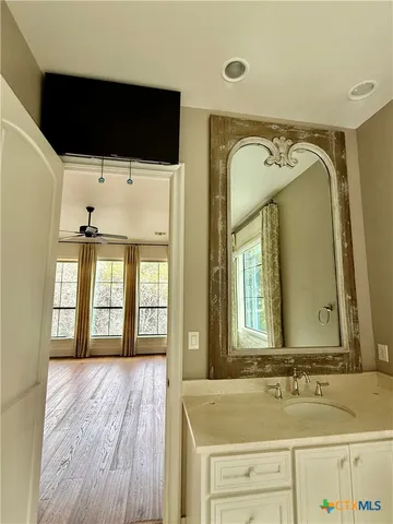 a bathroom with a sink a mirror and a bathtub