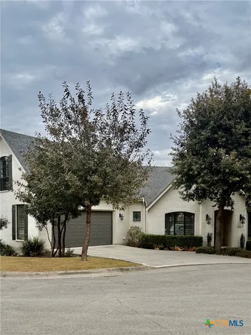 a house that has a tree in front of it