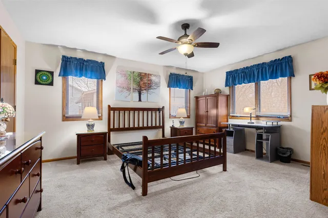 a bed sitting in a bedroom next to a window