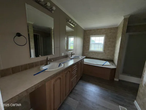 a bathroom with a double vanity sink and a mirror