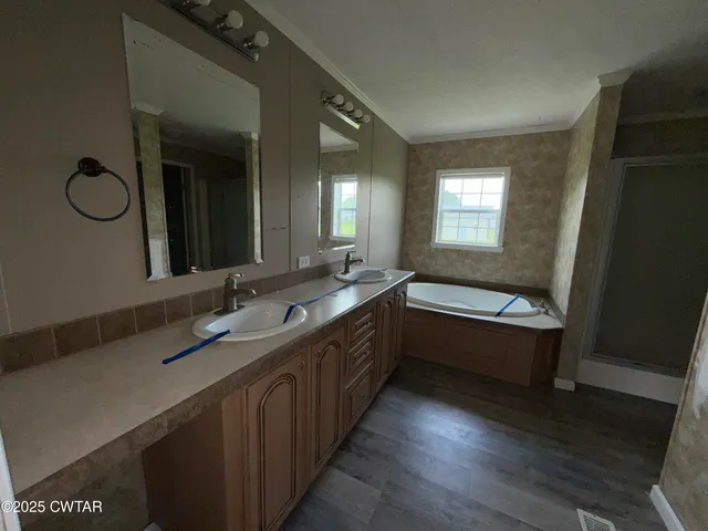 a bathroom with a double vanity sink and a mirror