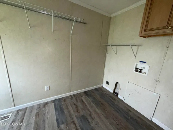 a view of a room with wooden floor and cabinet