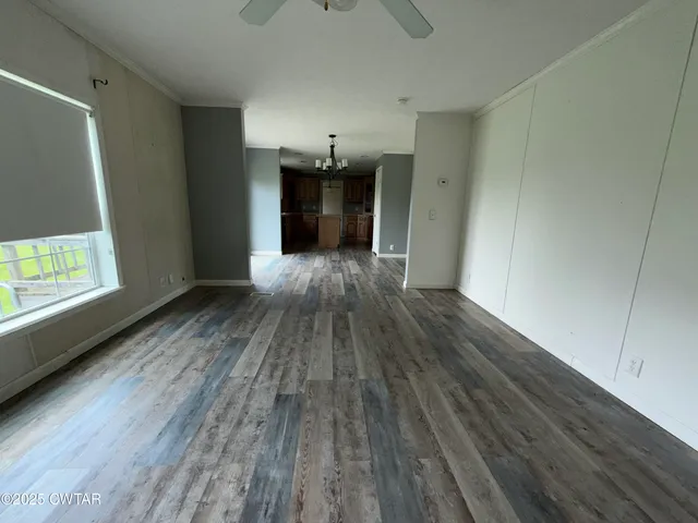 a view of a room with wooden floor and a window