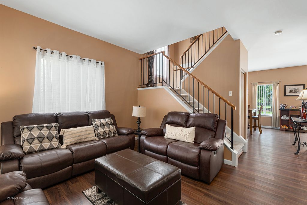 22202 West Niagara Trail, Unit 22202 Plainfield, IL 60544 - Photo 11 of 24 a living room with furniture and wooden floor