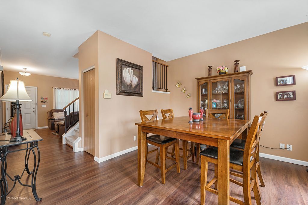 22202 West Niagara Trail, Unit 22202 Plainfield, IL 60544 - Photo 13 of 24 a dining room with furniture and wooden floor