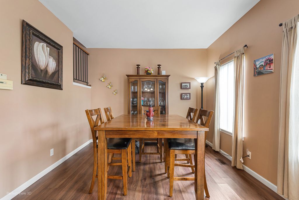 22202 West Niagara Trail, Unit 22202 Plainfield, IL 60544 - Photo 14 of 24 a view of a dining room with furniture and wooden floor