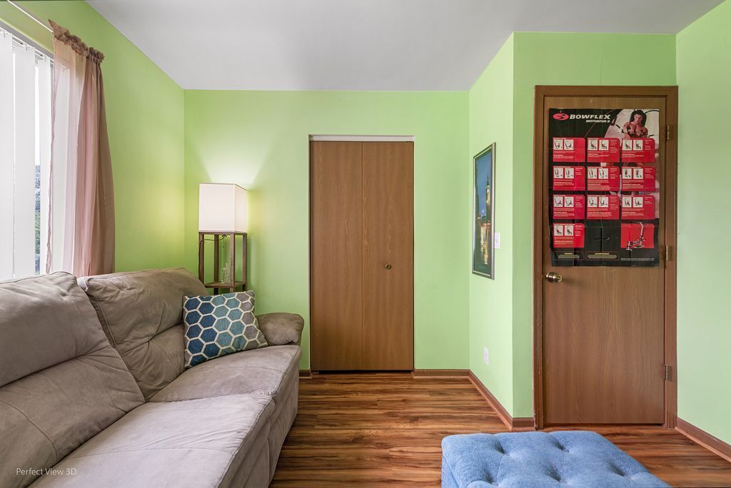 22202 West Niagara Trail, Unit 22202 Plainfield, IL 60544 - Photo 15 of 24 a living room with furniture and a wooden floor