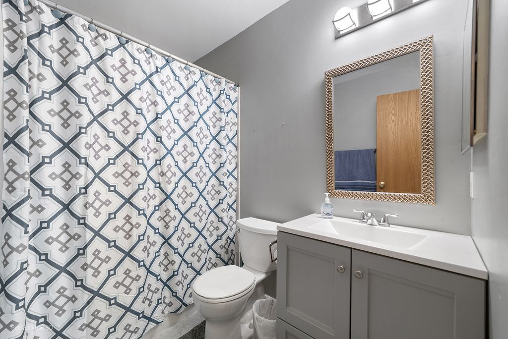 22202 West Niagara Trail, Unit 22202 Plainfield, IL 60544 - Photo 5 of 24 a bathroom with a granite countertop sink and a toilet
