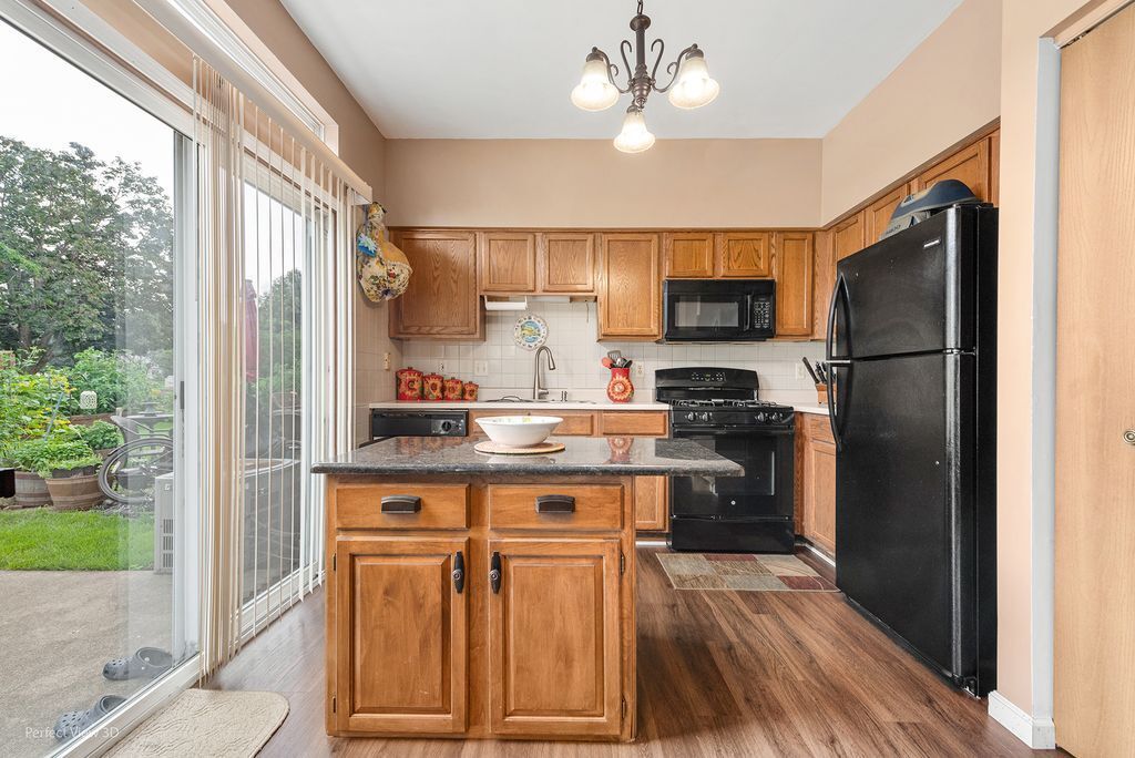 22202 West Niagara Trail, Unit 22202 Plainfield, IL 60544 - Photo 7 of 24 a kitchen with a refrigerator a sink and a stove