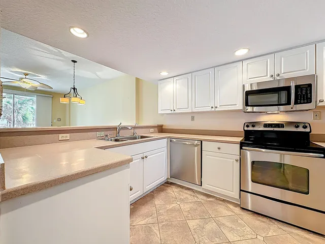 a kitchen with a sink stove and cabinets