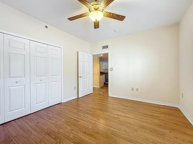 a view of an empty room with a ceiling fan