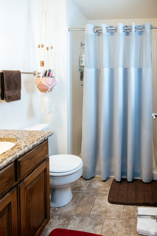 322 Bailey Creek Road Soda Springs, ID 83276 - Photo 13 of 32 Shower-tub combination with tile surround, complemented by a vanity featuring a granite-style countertop and wood-finish cabinetry