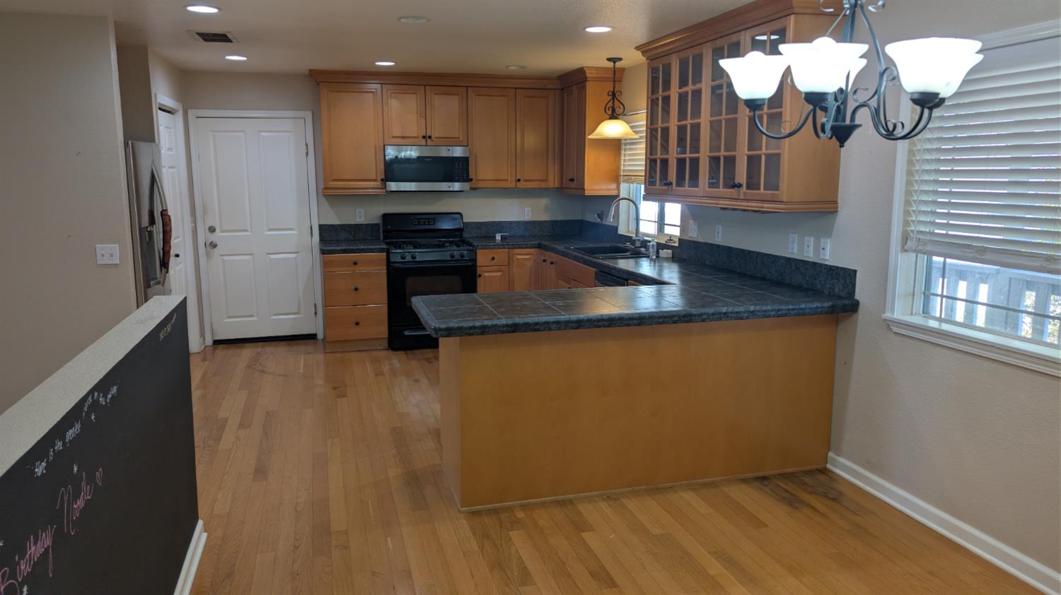 3248 Sudbury Road Cameron Park, CA 95682 - Photo 8 of 41 a kitchen with kitchen island granite countertop a sink cabinets and stainless steel appliances