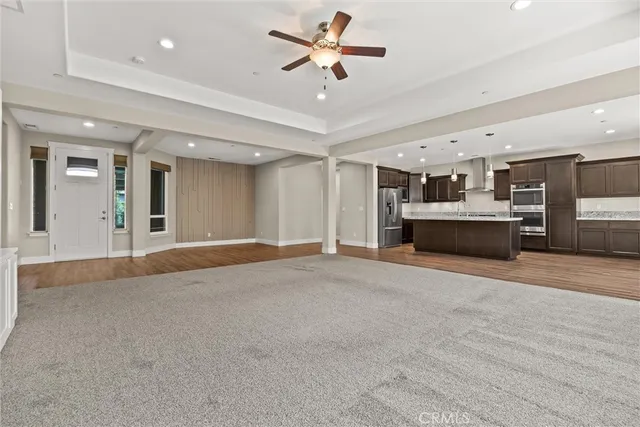 an empty room with windows and fireplace