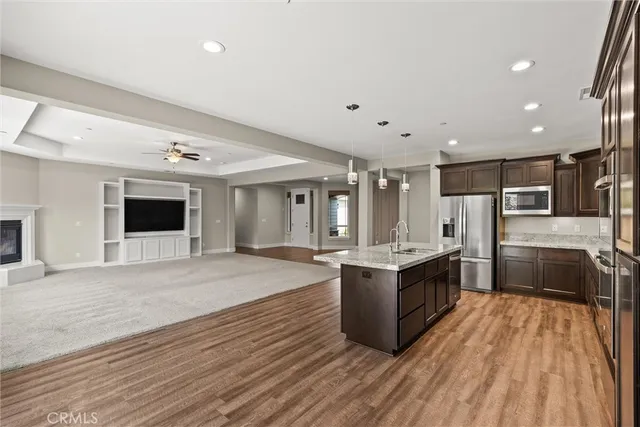 a kitchen with stainless steel appliances granite countertop a stove and a refrigerator