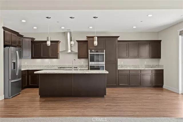 a kitchen with granite countertop kitchen island with windows and a sink