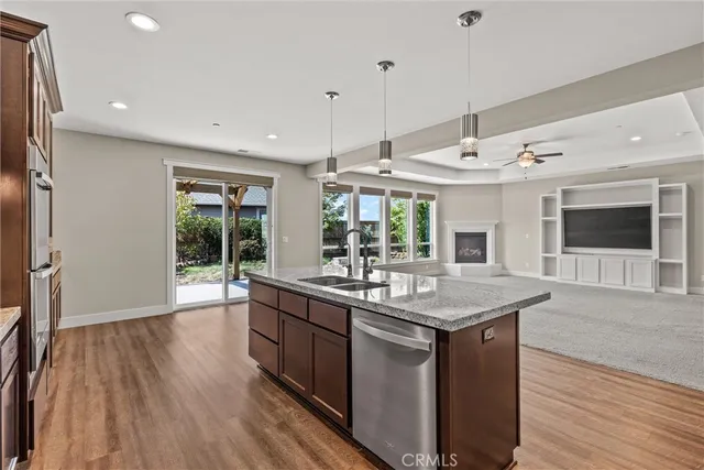 a kitchen with stainless steel appliances granite countertop a refrigerator and a sink