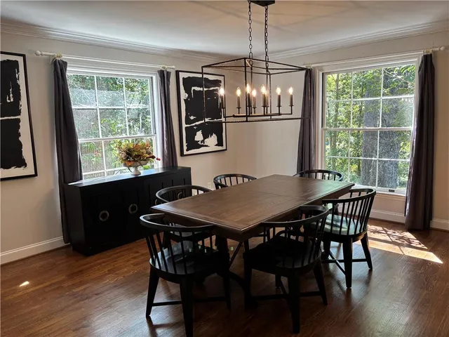 a view of a dining room with furniture window and wooden floor