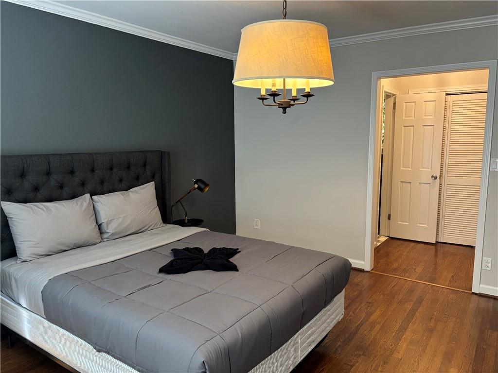 45 Blackland Road Northwest Atlanta, GA 30342 - Photo 15 of 31 a bedroom with a bed and a painting on the wall