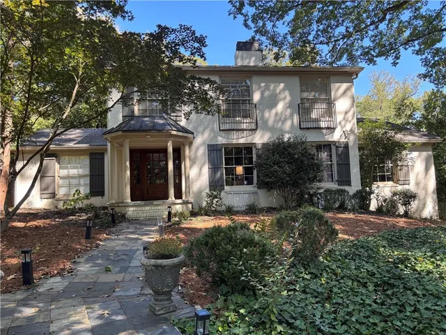 a front view of a house with sitting area