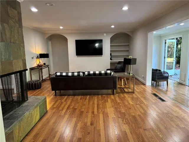 a view of a living room and kitchen with furniture